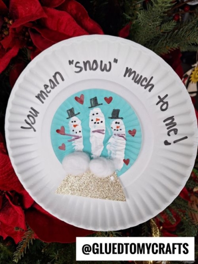 A Winter Themed Toddler Craft shows three snowmen made from white-painted fingerprints with hats, scarves, and faces. Red paper hearts and two cotton balls decorate the scene. Text reads, You mean snow much to me!.