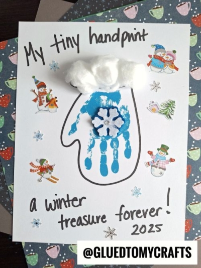 A Winter Themed Toddler Craft features a blue handprint shaped like a mitten, decorated with a snowflake, cotton ball “snow,” and winter stickers. The text says “My tiny handprint, a winter treasure forever! 2025.”.