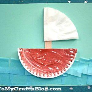 A paper plate boat craft features a painted plate as the hull, a stick mast, and a white paper sail, all set on a blue background. Inspired by coffee filter boats, it’s finished with tissue waves and small paper stars for decoration.