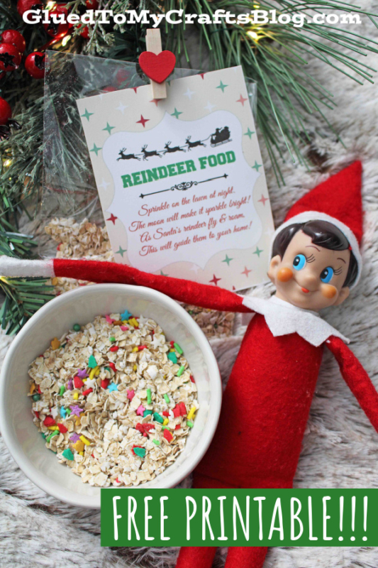 A festive scene features a bowl of reindeer food, an Elf on the Shelf plush, and a printed card with reindeer food instructions. Pine branches and Christmas décor decorate the background. Text overlay reads FREE PRINTABLE!!!.