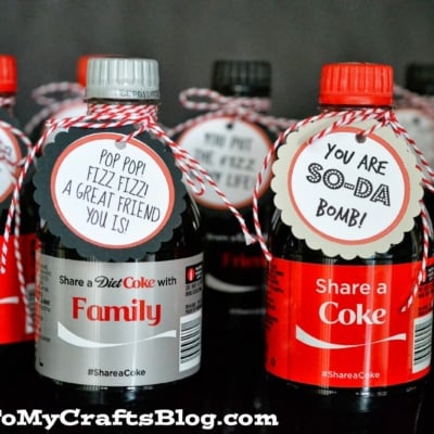 Several small Coke bottles with decorated tags that say friendly messages like YOU ARE SO-DA BOMB! and Pop pop fizz fizz! A great friend you is tied with red and white twine—perfect for free pay it forward ideas.