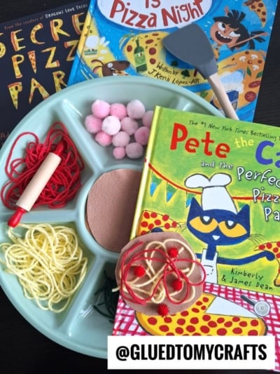 A craft tray holds yarn, pom-poms, felt, and a tool for Pretend Play Pizza Making, next to three children's books about pizza, including Pete the Cat and the Perfect Pizza Party. The image is labeled @GLUEDTOMYCRAFTS.