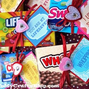 Several boxed candies decorated with colorful printable cards and red ribbons, each featuring sweet messages like You are my Lifesaver and I love you, sweetheart—perfect for Valentine's Day Candy Grams. A blog watermark appears at the bottom.