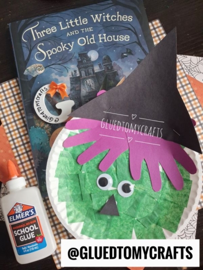 A children’s book, Three Little Witches and the Spooky Old House, is shown alongside a paper plate Halloween witch craft made from colored paper and googly eyes, plus a bottle of Elmer’s glue. @GLUEDTOMYCRAFTS is written below.
