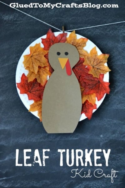 A Paper Plate Leaf Turkey craft made from a paper plate, artificial fall leaves, and brown paper shaped like a turkey, with LEAF TURKEY Kid Craft text below.