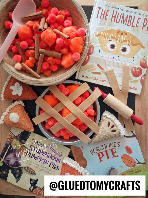 Flat lay of Thanksgiving pie-themed children’s crafts, including Pumpkin Pie felt pies, pom poms, toy utensils, and three picture books like The Humble Pie. Text overlay reads @GLUEDTOMYCRAFTS.