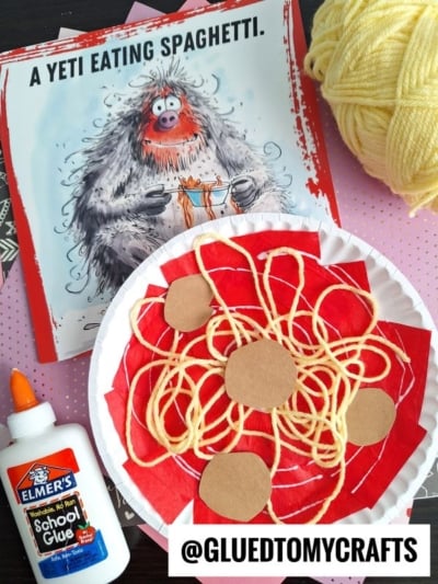 A children’s craft project inspired by A Yeti Eating Spaghetti features Paper Plate Spaghetti with red paper, yellow yarn as paper spaghetti, brown paper meatballs, school glue, a ball of yellow yarn, and the book cover.