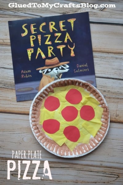 A children’s book titled Secret Pizza Party is behind a paper plate pizza craft made from brown, yellow, and red paper. Text reads Paper Plate Pizza, highlighting this fun and creative paper plate pizza activity.