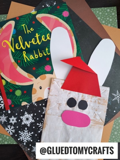 A children’s book, The Velveteen Rabbit, is shown with a handmade bunny craft featuring a red hat on patterned and colored paper sheets. This adorable display is perfect inspiration if you’re looking for how to make a bunny paper bag or create your own bunny paper bag puppet. Text reads @GLUEDTOMYCRAFTS.