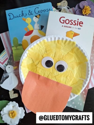 A paper plate duck craft with yellow tissue paper, large googly eyes, and an orange beak is displayed alongside children’s books Duck & Goose and Gossie, plus other paper duck kid craft creations on a colorful background.