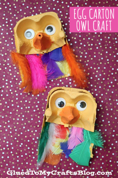 Two egg carton owls, crafted from yellow cartons with colorful feathers, googly eyes, and orange beaks, sit on a purple polka dot background. Text in the top right reads Egg Carton Owl Craft.
