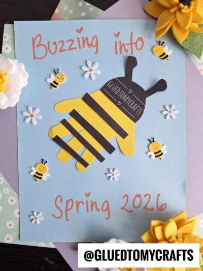 A spring-themed Easter Kid Craft featuring a bee made from a yellow paper handprint with black stripes, surrounded by paper flowers and bees. The text reads Buzzing into Spring 2026 and @GLUEDTOMYCRAFTS.