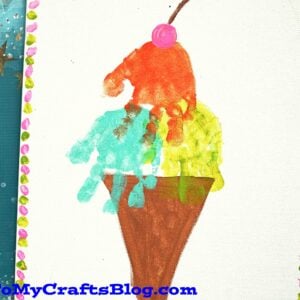 Close-up of a handprint ice cream cone craft with vibrant paint colors, showcasing a creative and sentimental kids' art project.