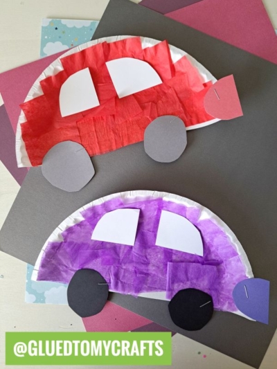 Two paper plate cars, one red and one purple, feature tissue paper, paper windows, and wheels, displayed on colorful backgrounds. The text reads @GLUEDTOMYCRAFTS.