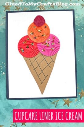 A fun ice cream kid craft featuring a cupcake liner ice cream cone with colorful scoops, decorated with sequins and set atop a brown paper cone with drawn lines, all displayed on a white background.