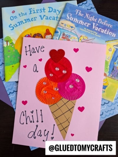 A handmade card featuring a cupcake liner ice cream cone and hearts says "Have a Chill day!"—a perfect ice cream kid craft, displayed atop children's summer vacation books. The @gluedtomycrafts watermark is at the bottom.