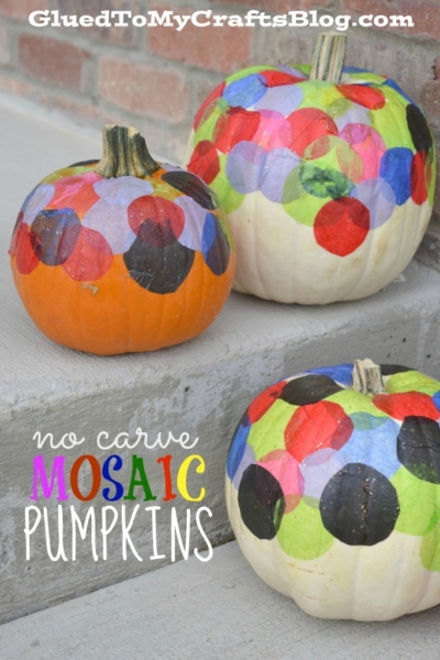 Three no carve pumpkins decorated with colorful tissue paper circles in a mosaic style sit on concrete steps. The text on the image reads Mosaic Pumpkins and GluedToMyCraftsBlog.com at the top.