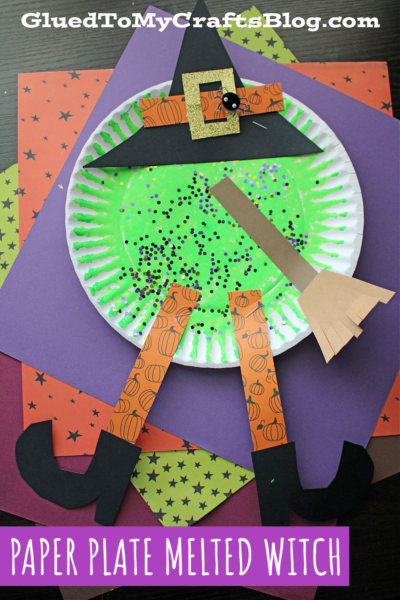 A whimsical melted witch craft features a green-painted paper plate, glitter, a paper hat, pumpkin-patterned legs, black boots, and a broom on colorful paper—perfectly labeled PAPER PLATE MELTED WITCH.