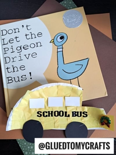 A children's book titled Don't Let the Pigeon Drive the Bus! is shown with a paper plate school bus craft in front. The craft has SCHOOL BUS written on it, black paper wheels, and @GLUEDTOMYCRAFTS at the bottom.