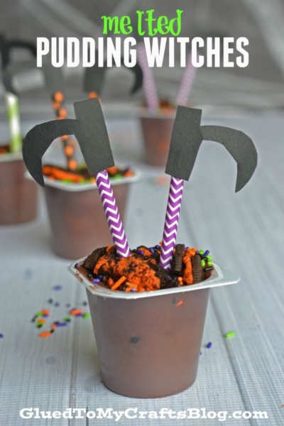 A chocolate pudding cup decorated with cookie crumbs, sprinkles, and two paper straws topped with black paper cutouts shaped like a witch's hat and broom, resembling melted pudding witches—a fun halloween melted pudding witches snack. Text reads Melted Pudding Witches.
