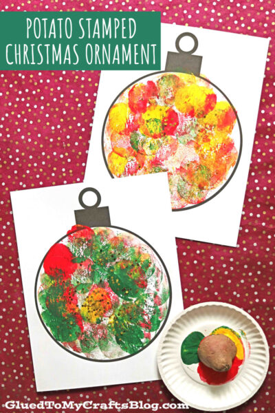 Two Christmas ornament templates are stamped with red, green, and yellow paint using a cut potato. A paint-covered potato and a plate of paint sit nearby on a red polka dot background. Text reads Potato Stamped Christmas Ornament craft idea.