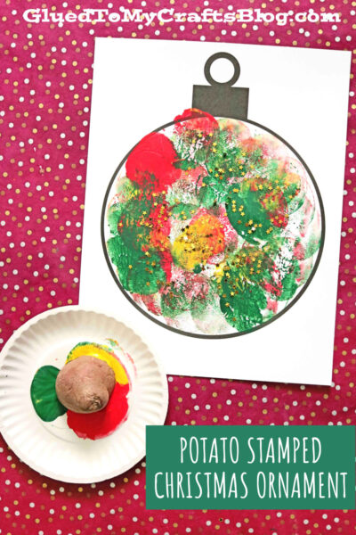 A piece of paper with a potato stamped Christmas ornament outline is decorated with red, green, and yellow paint. A potato and paint-covered plate are nearby on a red polka dot surface. Text: Potato Stamped Christmas Ornament.