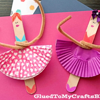 Three Popsicle Stick Ballerinas made with cupcake liners as skirts and brown pipe cleaners as arms