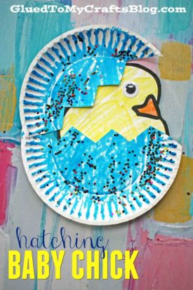 A colorful children’s craft features a paper plate hatching baby chick, with a yellow chick emerging from a blue egg decorated with patterns and glitter. The text reads, “hatching BABY CHICK.”.