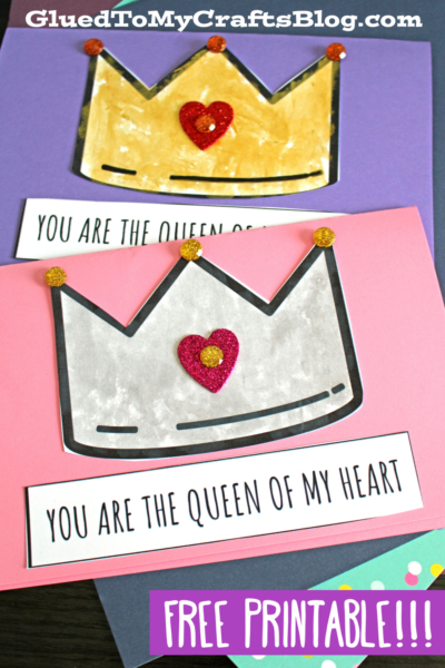 Two paper crowns, one gold and one silver, each featuring a glittery heart and the phrase Queen Of My Heart, are displayed on colorful backgrounds with a label reading Free Printable!!!.