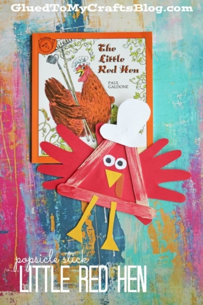 A craft book titled The Little Red Hen with a red hen illustration is paired with a charming popsicle stick little red hen craft, featuring red wings, yellow legs, googly eyes, and a white paper chef hat on a colorful background.