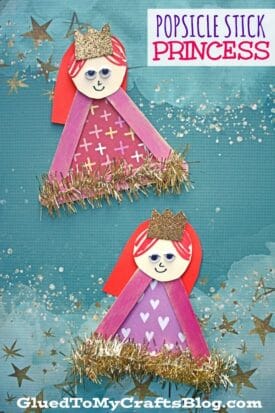 Two popsicle stick princess crafts with red hair, gold crowns, smiling faces, and triangle dresses decorated with glitter and tinsel, set against a blue starry background. Text reads Popsicle Stick Princess.