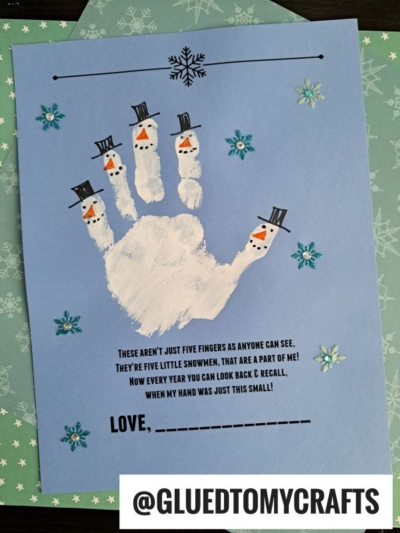A blue card features a whimsical snowman handprint, with each white finger transformed into a snowman complete with hats and charming faces. Snowflake stickers add wintry flair, while a short handprint snowman poem captures the season’s spirit. The handle @GLUEDTOMYCRAFTS appears at the bottom.