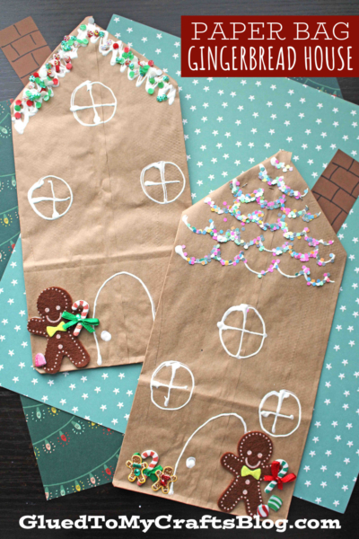 Two brown paper bags are decorated as gingerbread houses with white icing-like designs, candy stickers, and gingerbread men, set on patterned backgrounds. This fun paper bag gingerbread house craft is titled "Paper Bag Gingerbread House" at the top right.