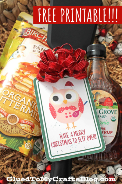 A Christmas gift set with pancake mix, syrup, a black spatula topped with a red bow, and a festive owl tag that says “Have a Merry Christmas to Flip Over!”—the perfect christmas to flip over for friends or family. FREE PRINTABLE!!!.