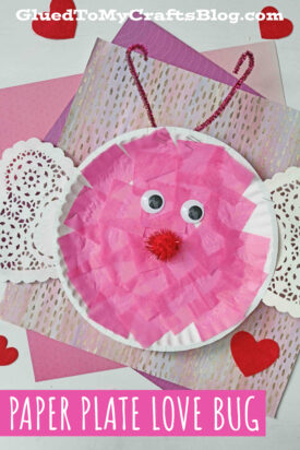 A paper plate with a tissue paper love bug and paper on it.