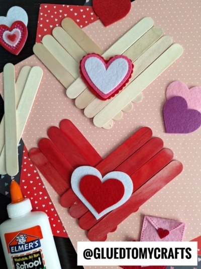 Craft supplies for making popsicle stick hearts with felt and patterned paper. Learn how to make a heart out of popsicle sticks—one simple, one layered for a 3D effect. @GLUEDTOMYCRAFTS text at bottom.