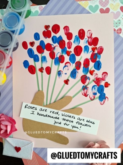 A charming fingerprint valentine card features red and blue fingerprint flowers with green stems. A brown hand cutout holds the bouquet, and a sweet note says, "Roses are red, violets are blue, I handmade these flowers just for you!.