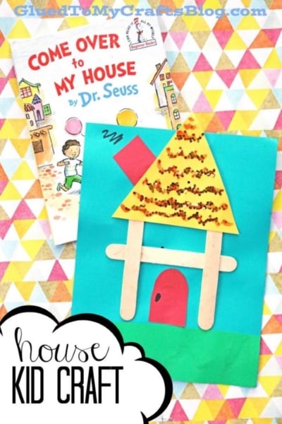Colorful kids craft inspired by Come Over to My House by Dr. Seuss, featuring a house and ABCs in popsicle sticks, with paper shapes and glitter on a blue background. Text overlay reads house KID CRAFT.