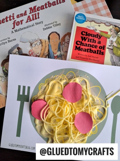 A handmade yarn spaghetti craft of spaghetti and meatballs using yellow yarn and pink paper sits on a plate illustration beside math-themed children's books about spaghetti and meatballs. @GLUEDTOMYCRAFTS is written at the bottom.