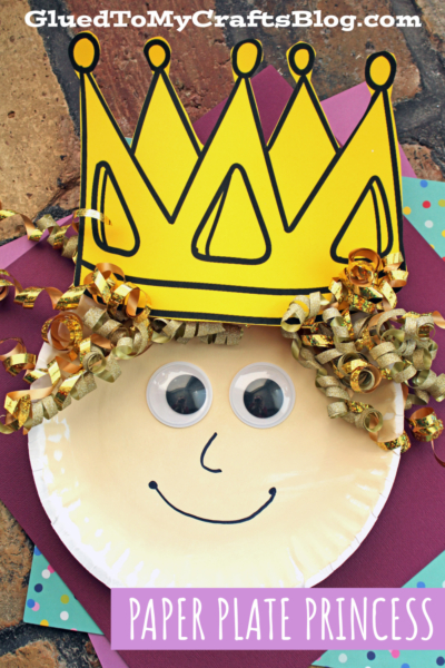 A paper plate princess craft features a princess face with large googly eyes, a drawn smile, curly gold ribbon hair, and a big yellow paper crown. The background pops with colorful papers. Text reads Paper Plate Princess.