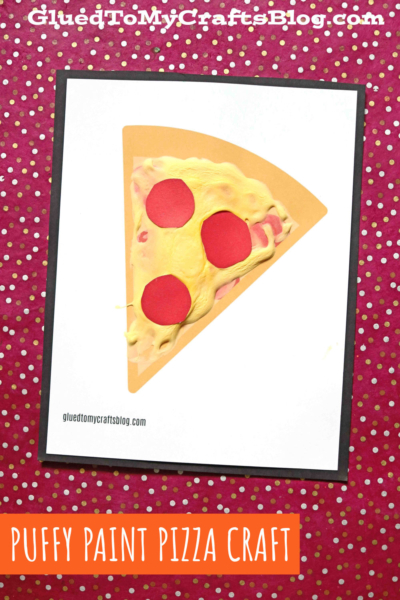 A handmade puffy paint pizza craft features a slice on white paper, topped with yellow puffy paint cheese and red paper pepperoni, set against a red polka dot background. Text reads: Puffy Paint Pizza Craft.