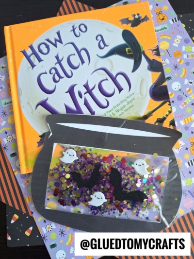 A Halloween-themed flat lay featuring the book How to Catch a Witch, Halloween-patterned papers, and a stained glass witch cauldron-inspired DIY sensory bag filled with sequins, glitter, and ghost and bat shapes.