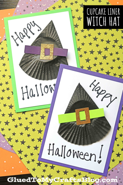 Two handmade cupcake liner witch hat cards with witch hats crafted from black cupcake liners and paper buckles, displayed on star-patterned paper. The cards say Happy Halloween! in playful writing.