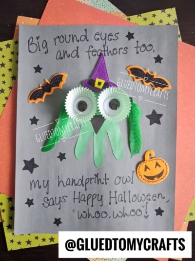 A Halloween craft with a green handprint owl, cupcake liner eyes, felt beak, and witch hat, decorated with bat and pumpkin stickers—perfect for creating halloween keepsakes. Text reads: My handprint owl says Happy Halloween whoo, whoo!.