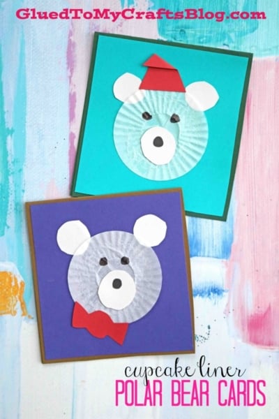 Two handmade polar bear cards feature faces crafted from white cupcake liners and paper. One cupcake liner polar bear sports a red hat, the other a red bowtie. Both cards have colorful square backgrounds and button noses.