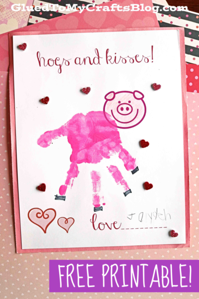 A Valentines Day card features a pink handprint pig surrounded by small heart stickers. Text reads hogs and kisses!, “love,” with space for a name. A purple label at the bottom says FREE PRINTABLE!.