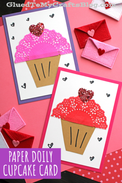 Two handmade paper doily cupcake cards with glitter hearts, surrounded by small paper envelopes and heart doodles. Text reads: Paper Doily Cupcake Card on a purple label.