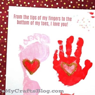 A card with a pink footprint and red handprint, each decorated with a gold-trimmed heart, above two cartoon owls. Text reads: “From the Bottom of My Toes to the tips of my fingers, I love you!”.