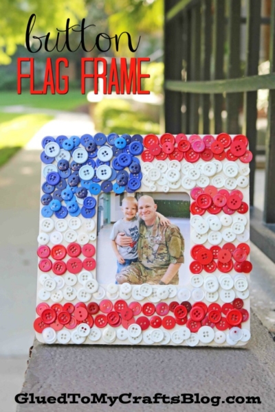 A square button flag wooden frame decorated with red, white, and blue buttons in an American flag pattern displays a picture of a smiling man in military uniform and a child. Text reads button FLAG FRAME.