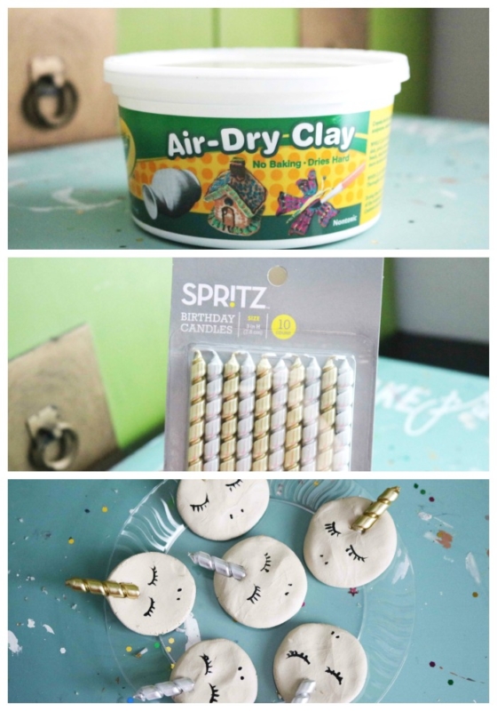A container of air-dry clay, a pack of striped birthday candles, and round clay unicorn magnets with closed eyes and gold horns are arranged on a blue surface.